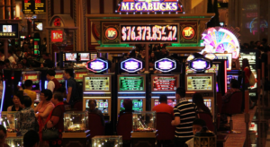 A crowded casino floor with people playing slot machines under the Megabucks jackpot sign